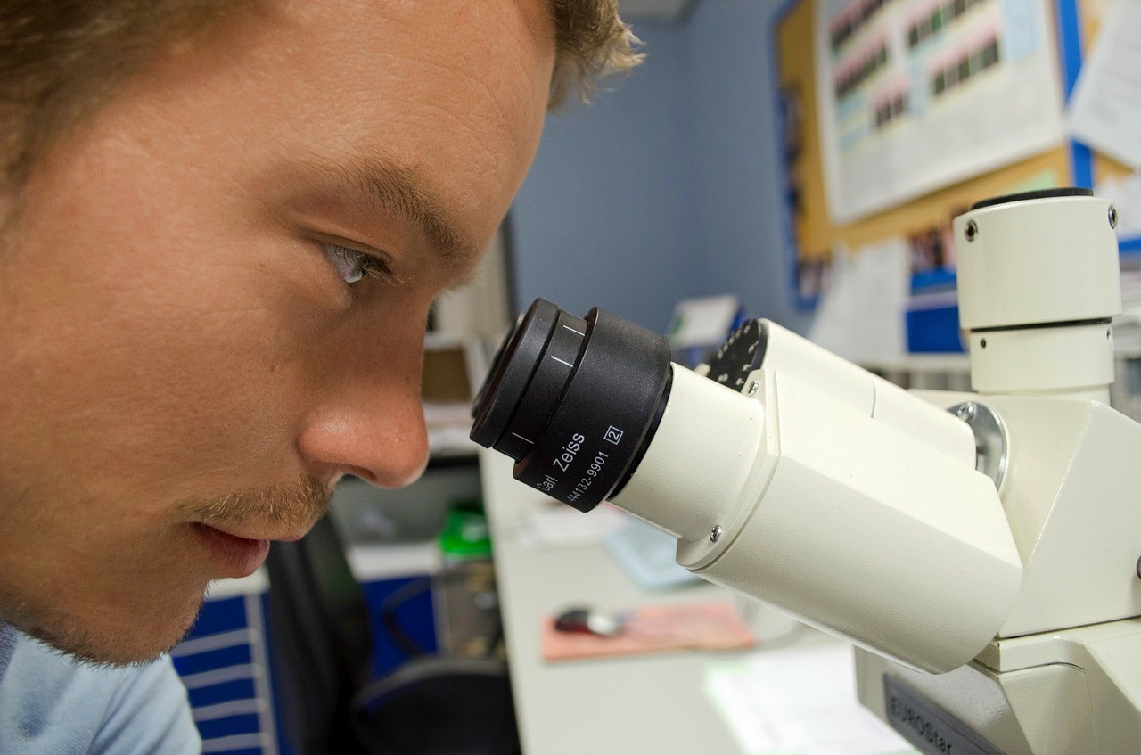 guy looking through a microscope